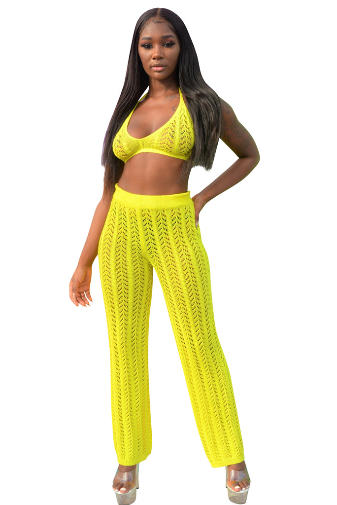 Pants Set. Featuring a see through knit design. Bikini top, matching pants with an elastic waist and flare bottom. 