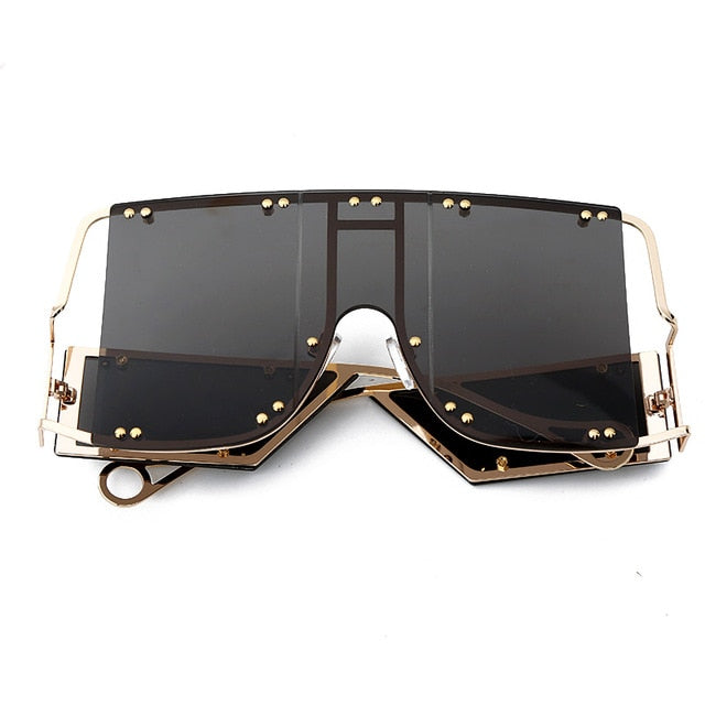 black color pop shades. Featuring an gold frame oversized square design trimmed in gold.  Theses special sunglasses change colors in different lighting. 